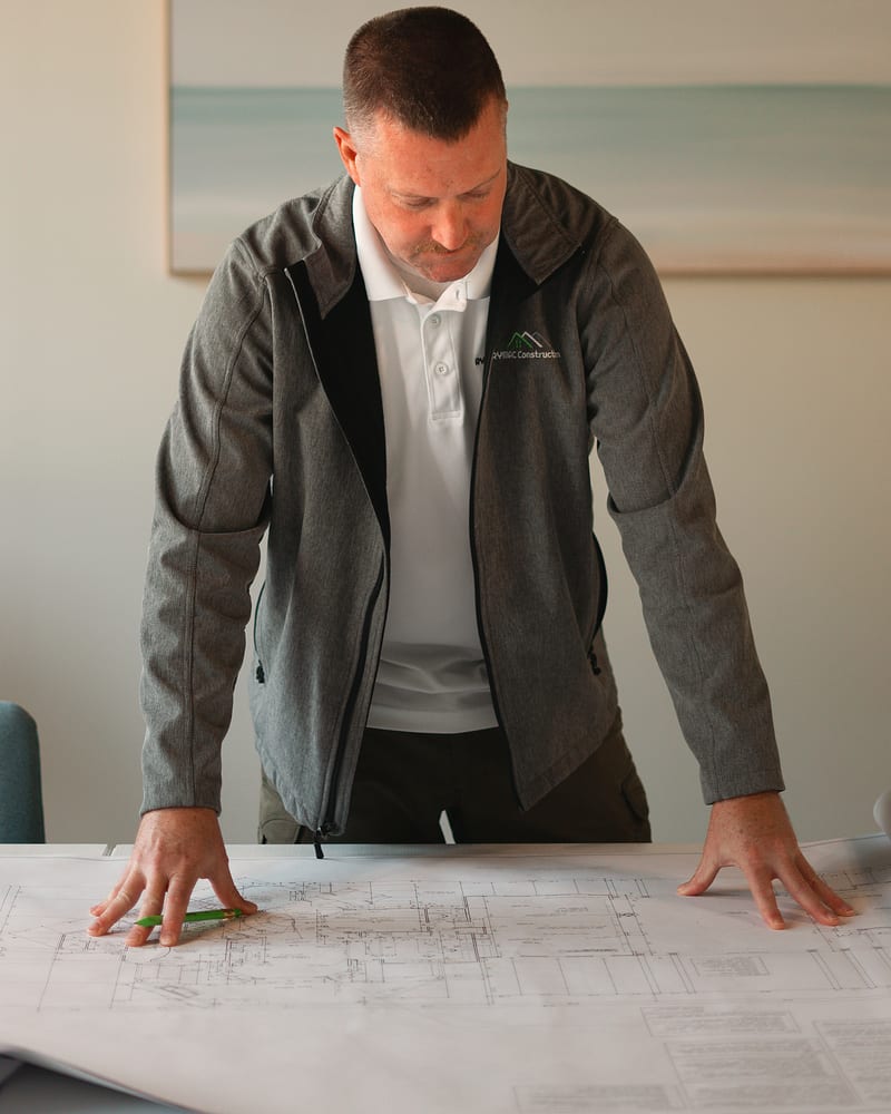 Ryan McDonald, RYMAC Construction owner, reviewing project plans